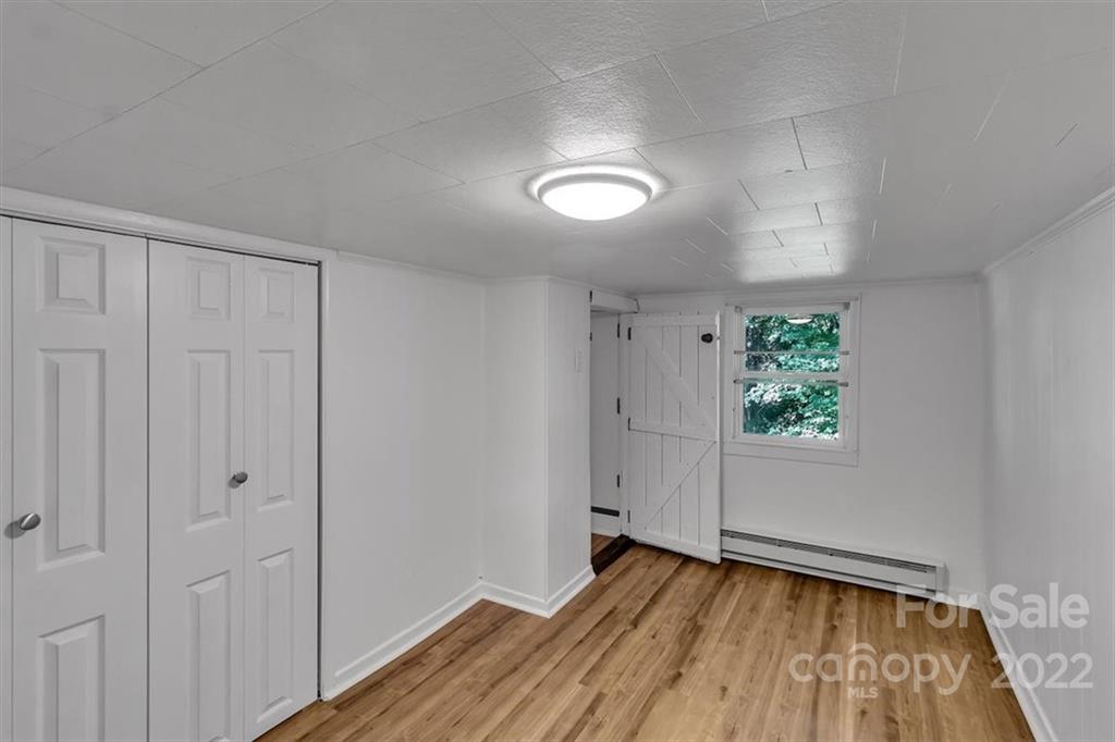 219 Star Ridge Road Canton, NC 28716 - Photo 16 of 27 wooden floor in an empty room with a window