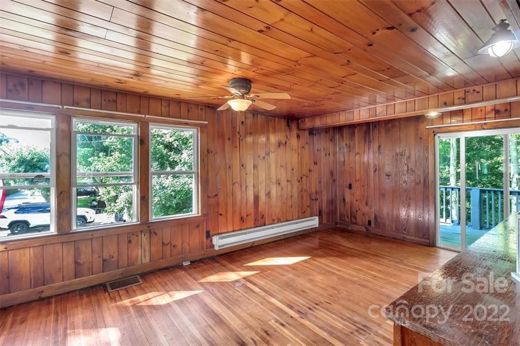 219 Star Ridge Road Canton, NC 28716 - Photo 6 of 27 an empty room with wooden floor and windows