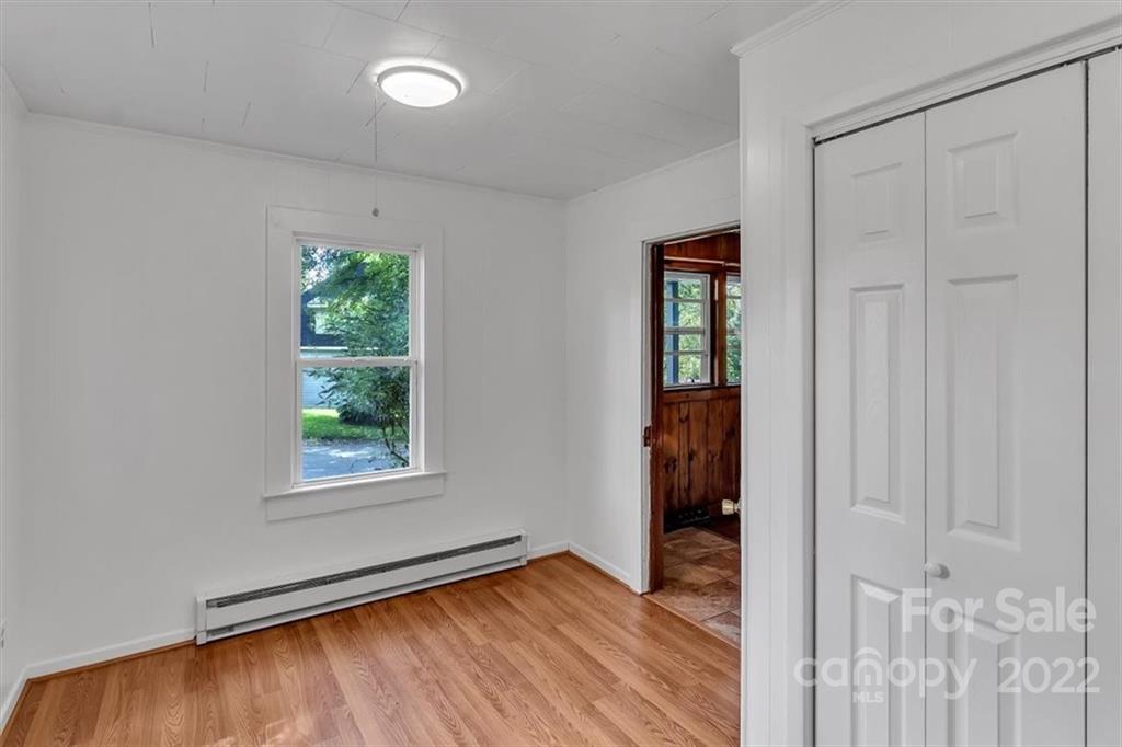 219 Star Ridge Road Canton, NC 28716 - Photo 10 of 27 an empty room with wooden floor and a window
