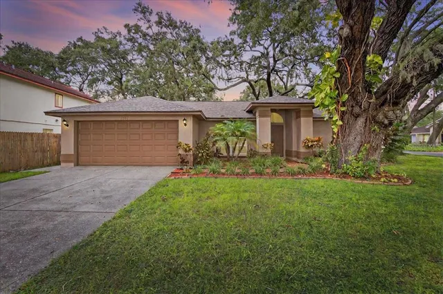 a front view of house with yard and trees