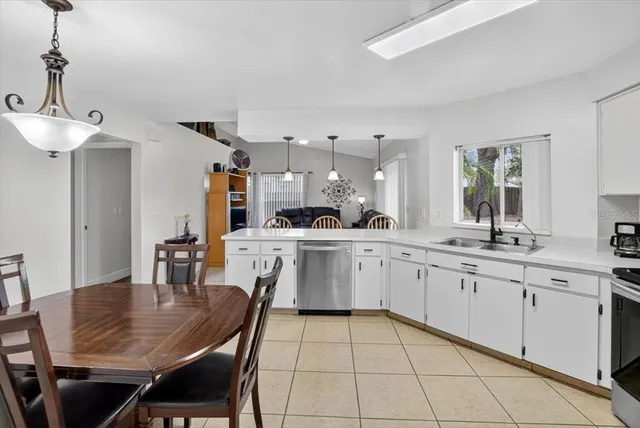 a living room with furniture a flat screen tv and a window
