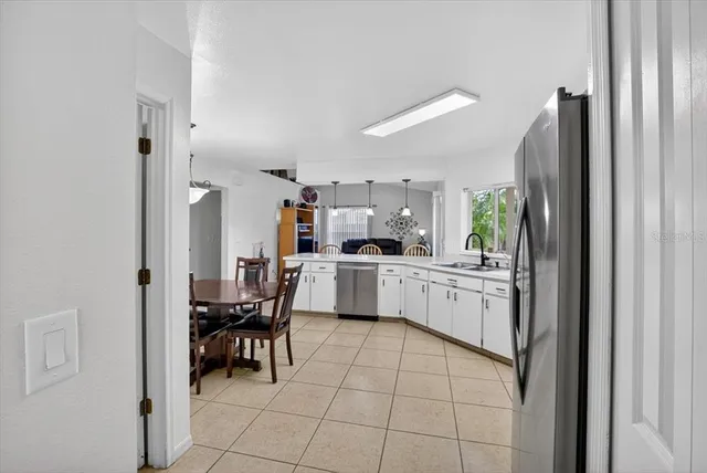 a bedroom with a large bed and a flat tv screen on dresser