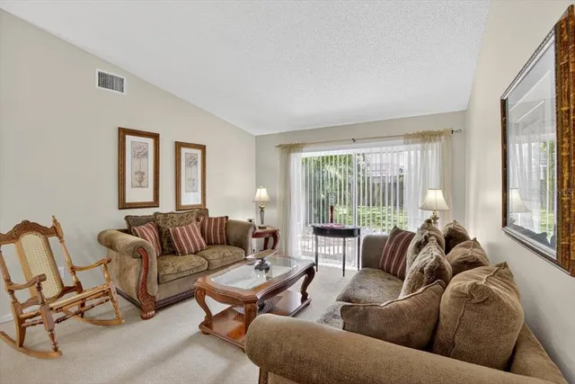 a kitchen with a dining table chairs and white cabinets