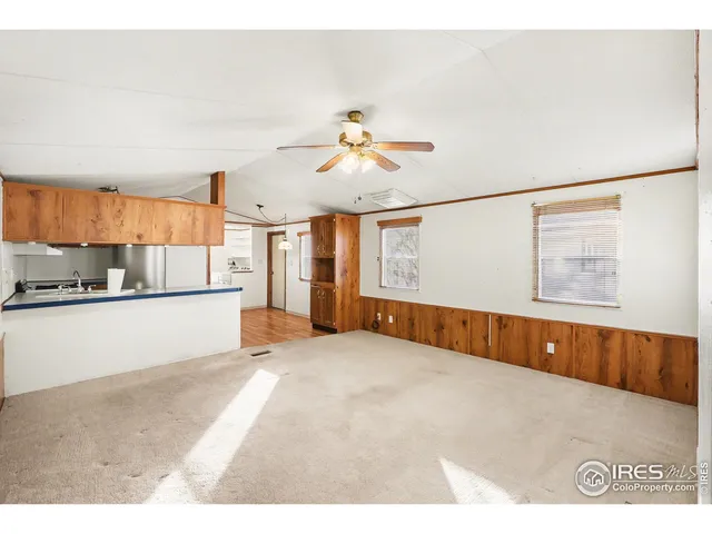 a view of a kitchen with a sink cabinets and a ceiling fan