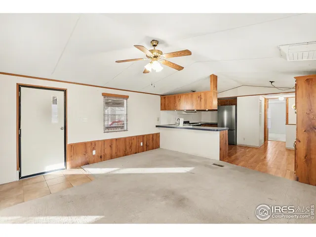 a living room with stainless steel appliances kitchen island granite countertop furniture and a kitchen view