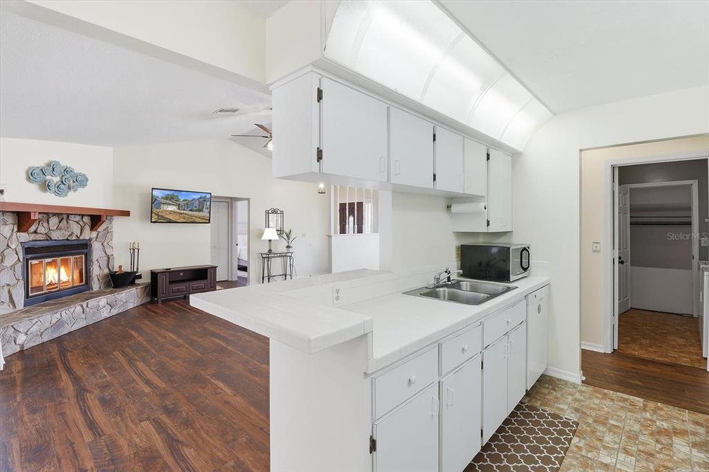 4601 South Gator Loop Homosassa, FL 34448 - Photo 12 of 49 a kitchen that has a lot of white cabinets and wooden floor
