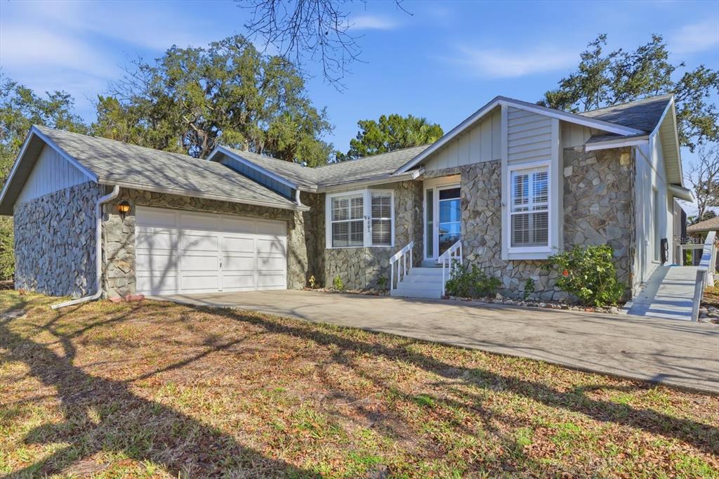 4601 South Gator Loop Homosassa, FL 34448 - Photo 13 of 49 a front view of a house with a yard and a garage
