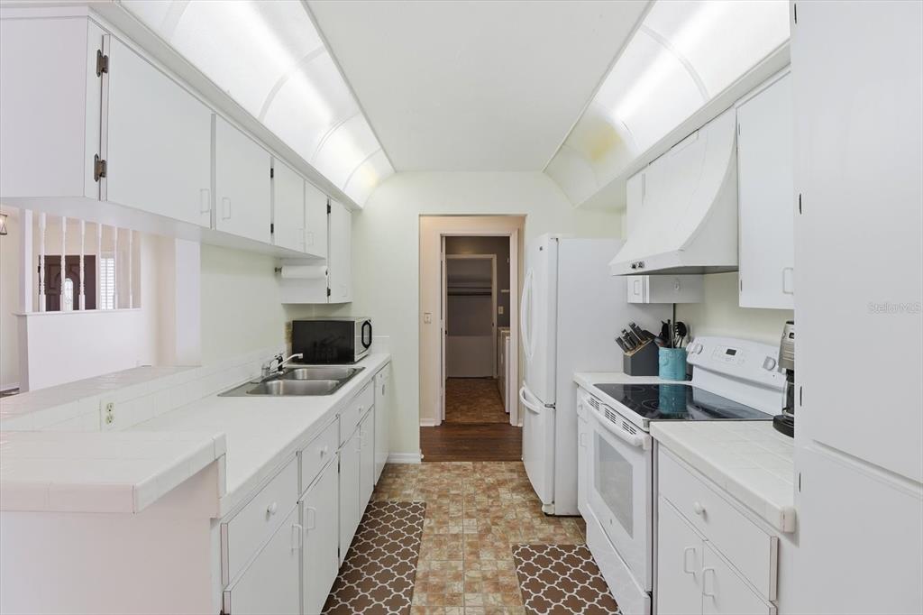 4601 South Gator Loop Homosassa, FL 34448 - Photo 14 of 49 a kitchen with stainless steel appliances a sink stove and cabinets