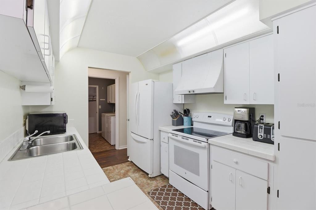 4601 South Gator Loop Homosassa, FL 34448 - Photo 15 of 49 a kitchen with stainless steel appliances a stove a sink and white cabinets