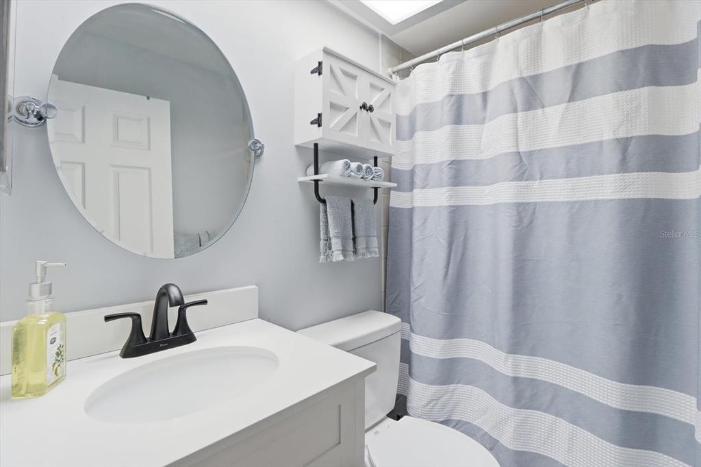 4601 South Gator Loop Homosassa, FL 34448 - Photo 24 of 49 a bathroom with a sink a toilet and shower curtain