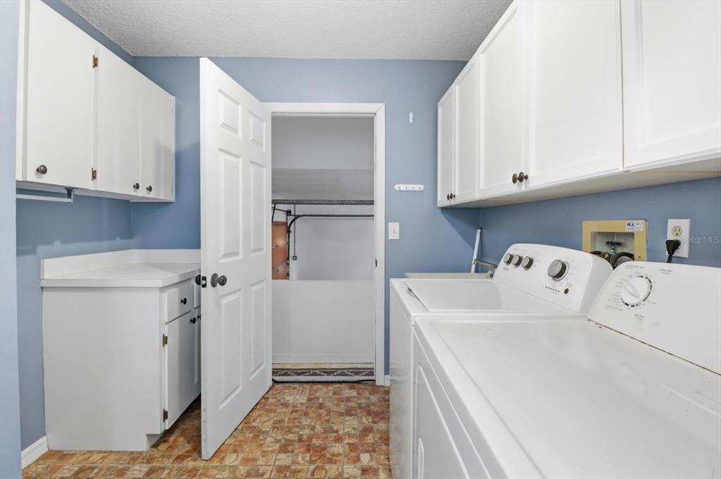 4601 South Gator Loop Homosassa, FL 34448 - Photo 29 of 49 a utility room with cabinets washer and dryer