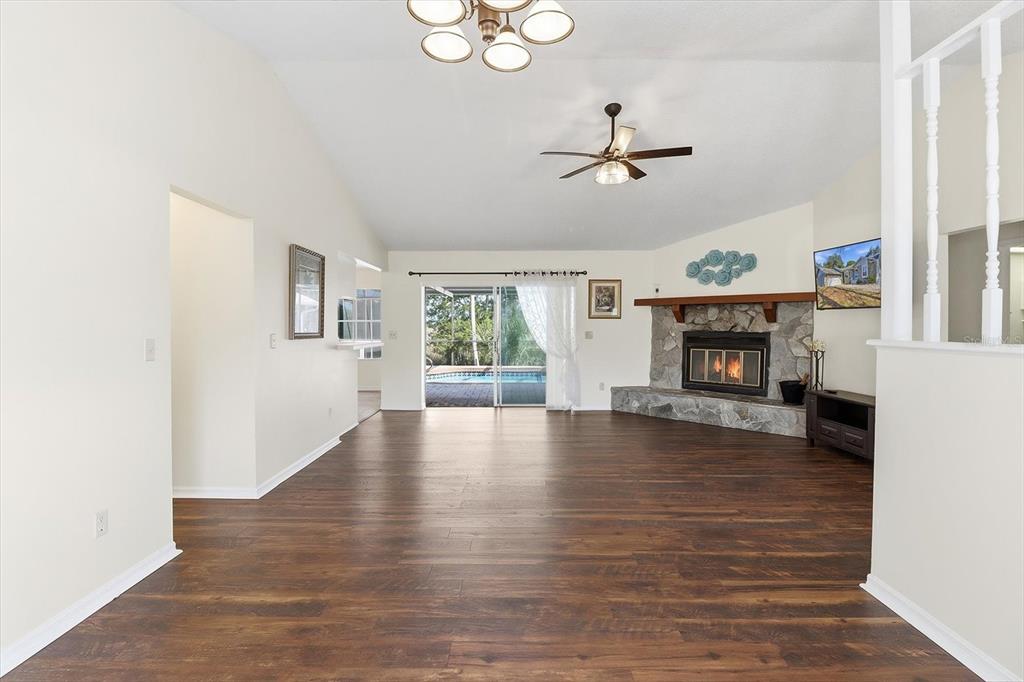 4601 South Gator Loop Homosassa, FL 34448 - Photo 7 of 49 a view of empty room with fireplace and wooden floor