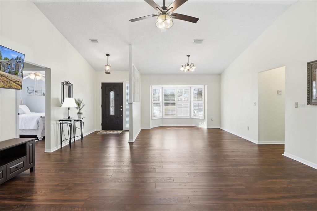 4601 South Gator Loop Homosassa, FL 34448 - Photo 9 of 49 a view of an empty room with wooden floor and a window