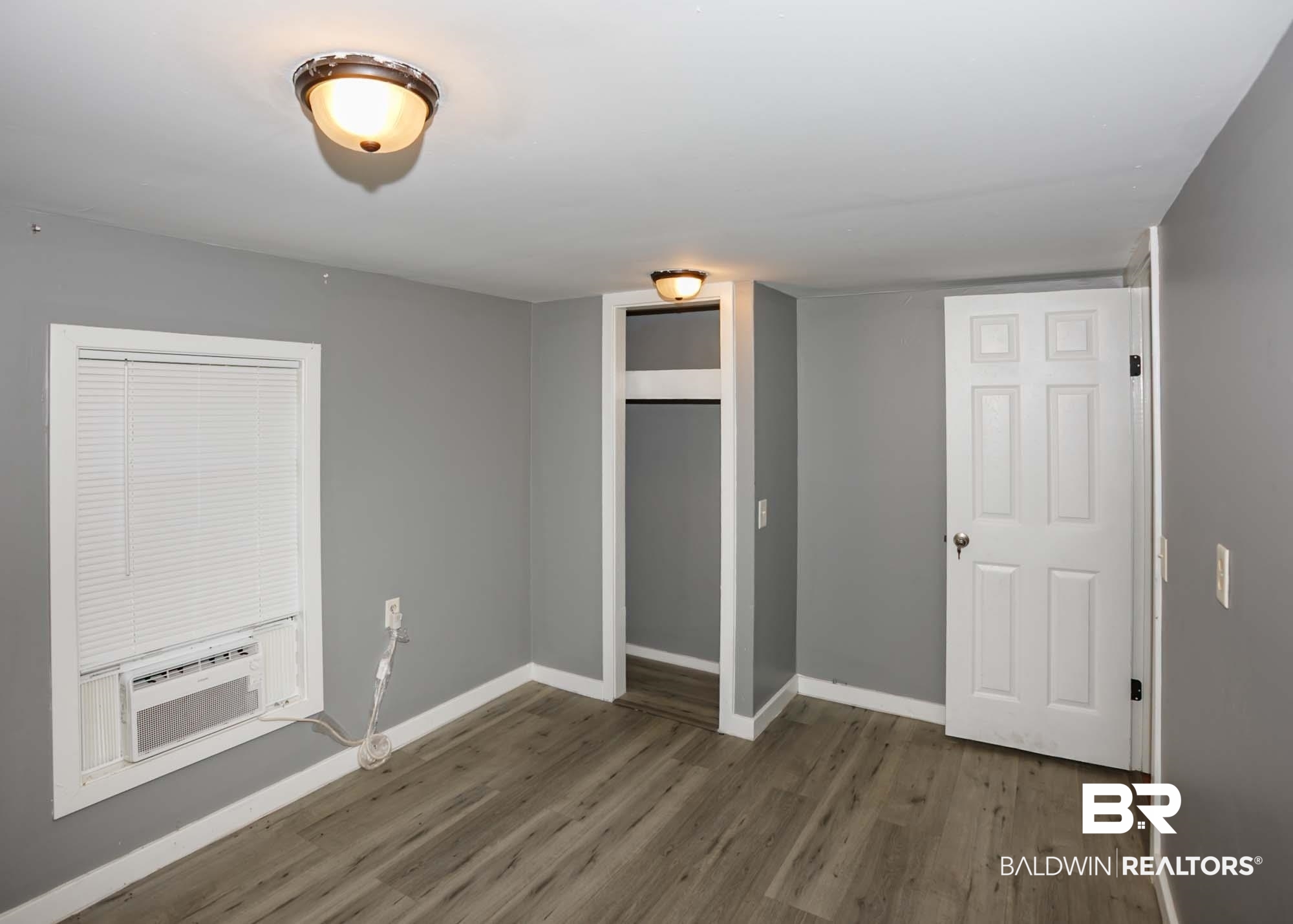 11998 Workman Avenue Foley, AL 36535 - Photo 51 of 59 Unfurnished bedroom with wood finished floors and a closet