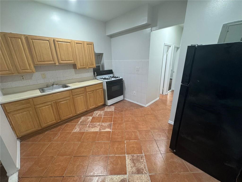 2120 Vyse Avenue, Unit 2 Bronx, NY 10460 - Photo 6 of 7 a kitchen with granite countertop a refrigerator and a sink
