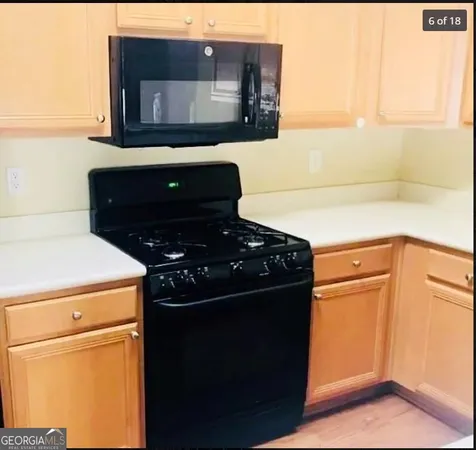 a kitchen with a refrigerator and a stove