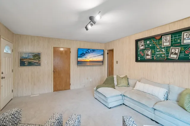 a living room with furniture and a wall painting