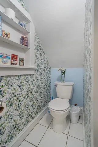 a bathroom with a toilet and a shower curtain
