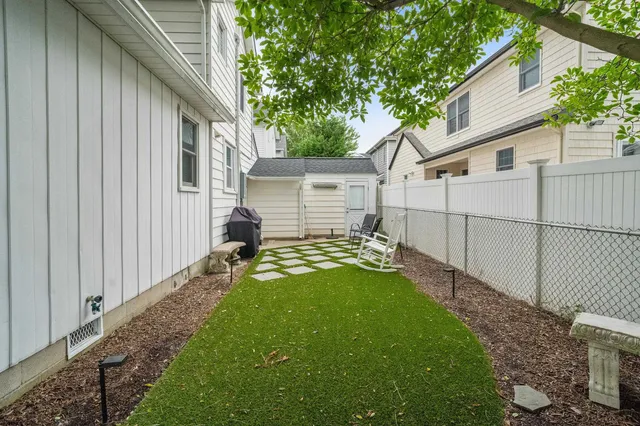 a backyard of a house with table and chairs