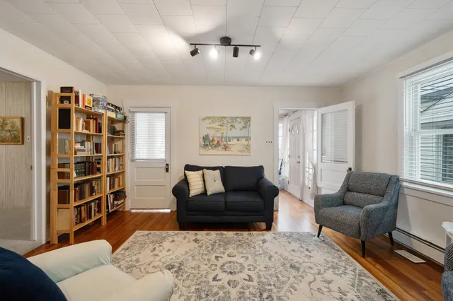 a living room with furniture and a book shelf