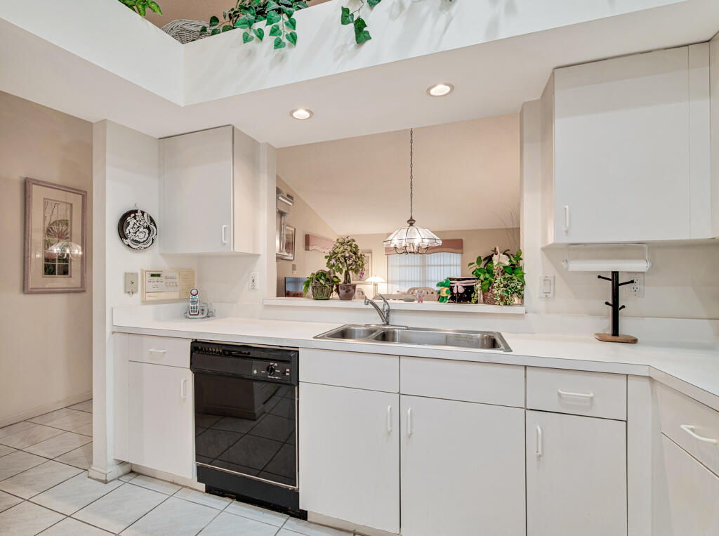 9976 Seacrest Circle, Unit A Boynton Beach, FL 33437 - Photo 14 of 48 a kitchen with a sink and cabinets
