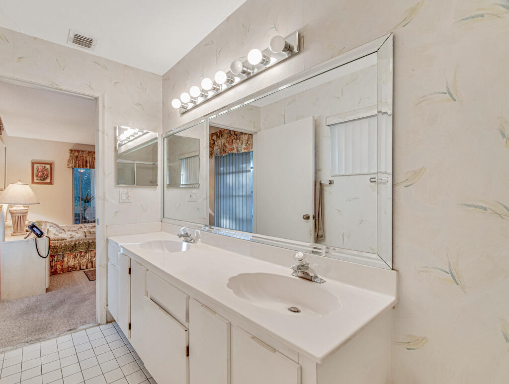 9976 Seacrest Circle, Unit A Boynton Beach, FL 33437 - Photo 21 of 48 a bathroom with a sink and a mirror