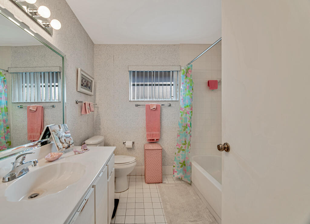 9976 Seacrest Circle, Unit A Boynton Beach, FL 33437 - Photo 26 of 48 a bathroom with a sink toilet and shower
