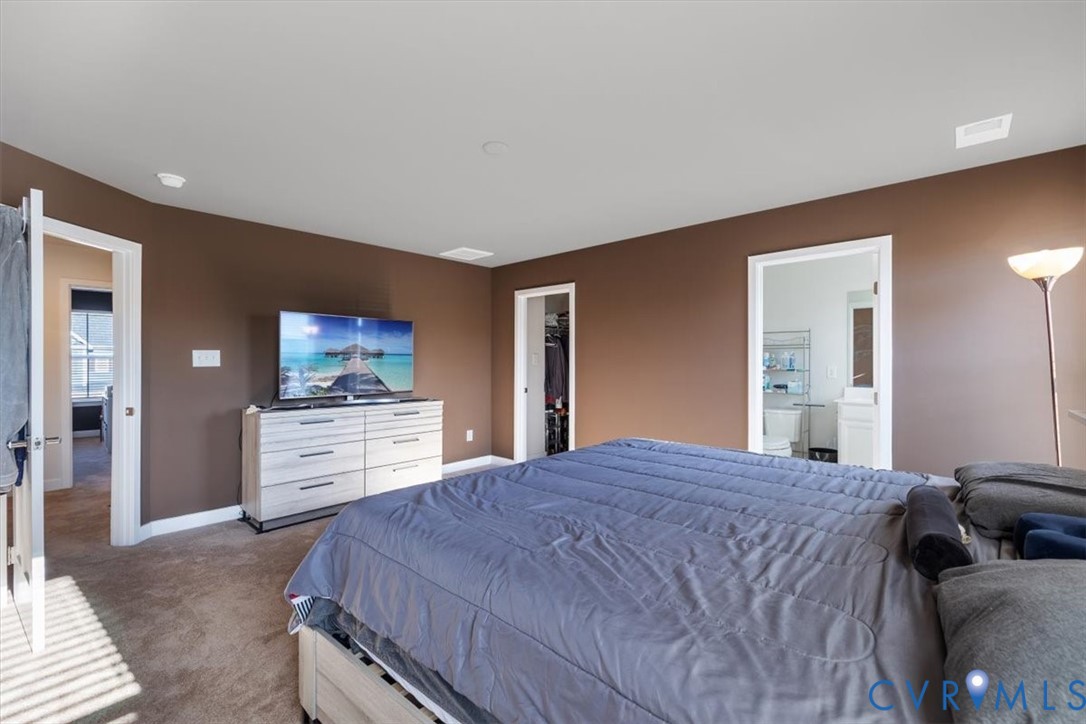 9002 Spring Green Loop Mechanicsville, VA 23116 - Photo 12 of 47 Carpeted bedroom with a walk in closet and ensuite