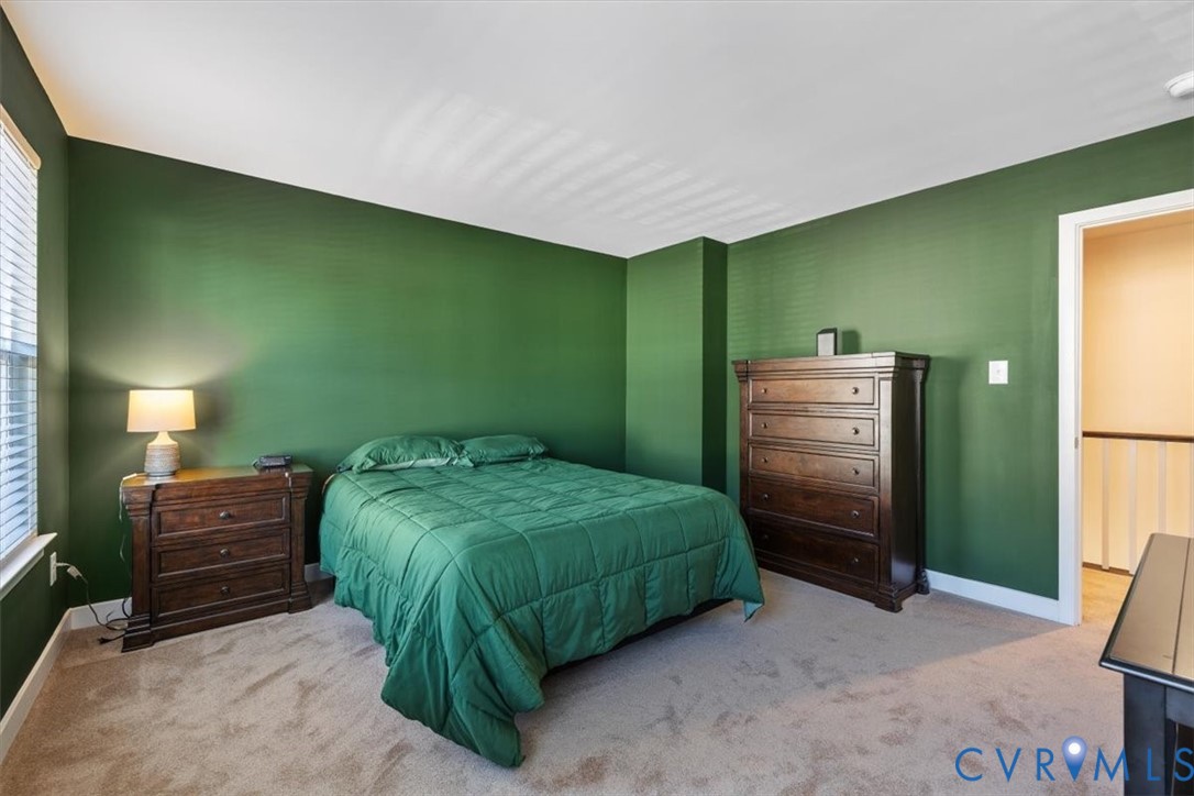 9002 Spring Green Loop Mechanicsville, VA 23116 - Photo 16 of 47 Bedroom with light colored carpet and baseboards