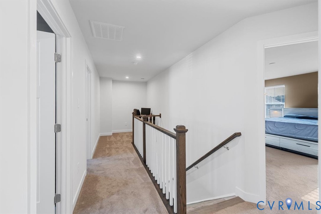9002 Spring Green Loop Mechanicsville, VA 23116 - Photo 19 of 47 Corridor featuring light colored carpet, an upstai