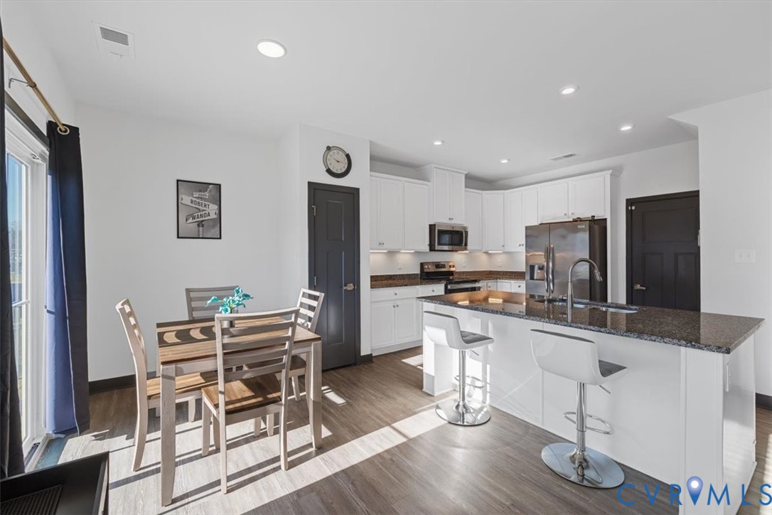 9002 Spring Green Loop Mechanicsville, VA 23116 - Photo 8 of 47 Kitchen with white cabinets, dark stone countertop