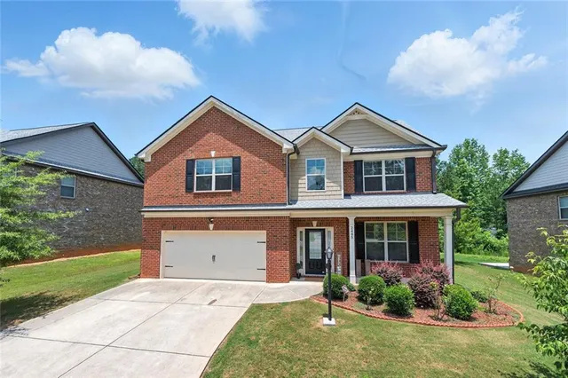 a front view of a house with garden