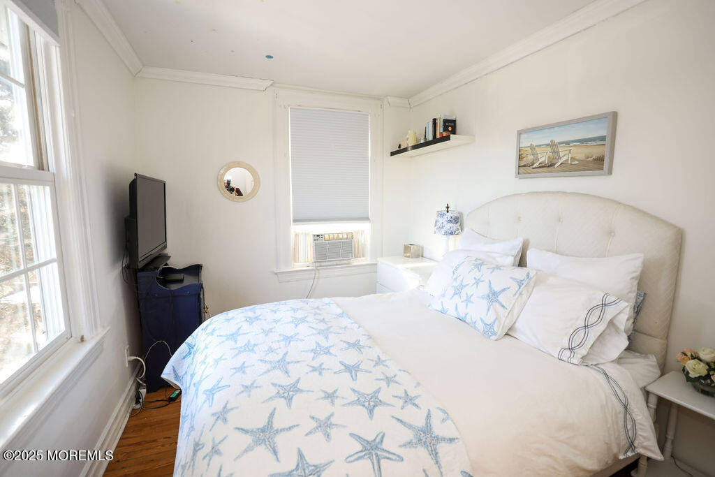 17 Beach Road Monmouth Beach, NJ 07750 - Photo 34 of 44 a bedroom with a bed and a flat tv screen on the dresser