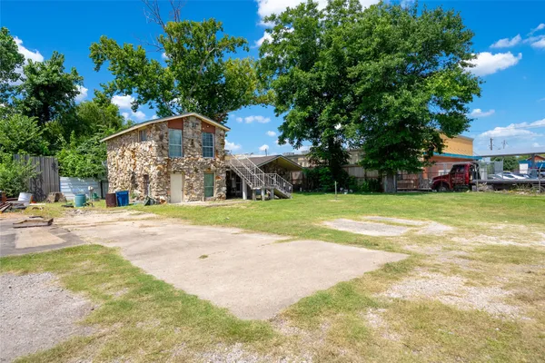 a view of a house with a yard and sitting area