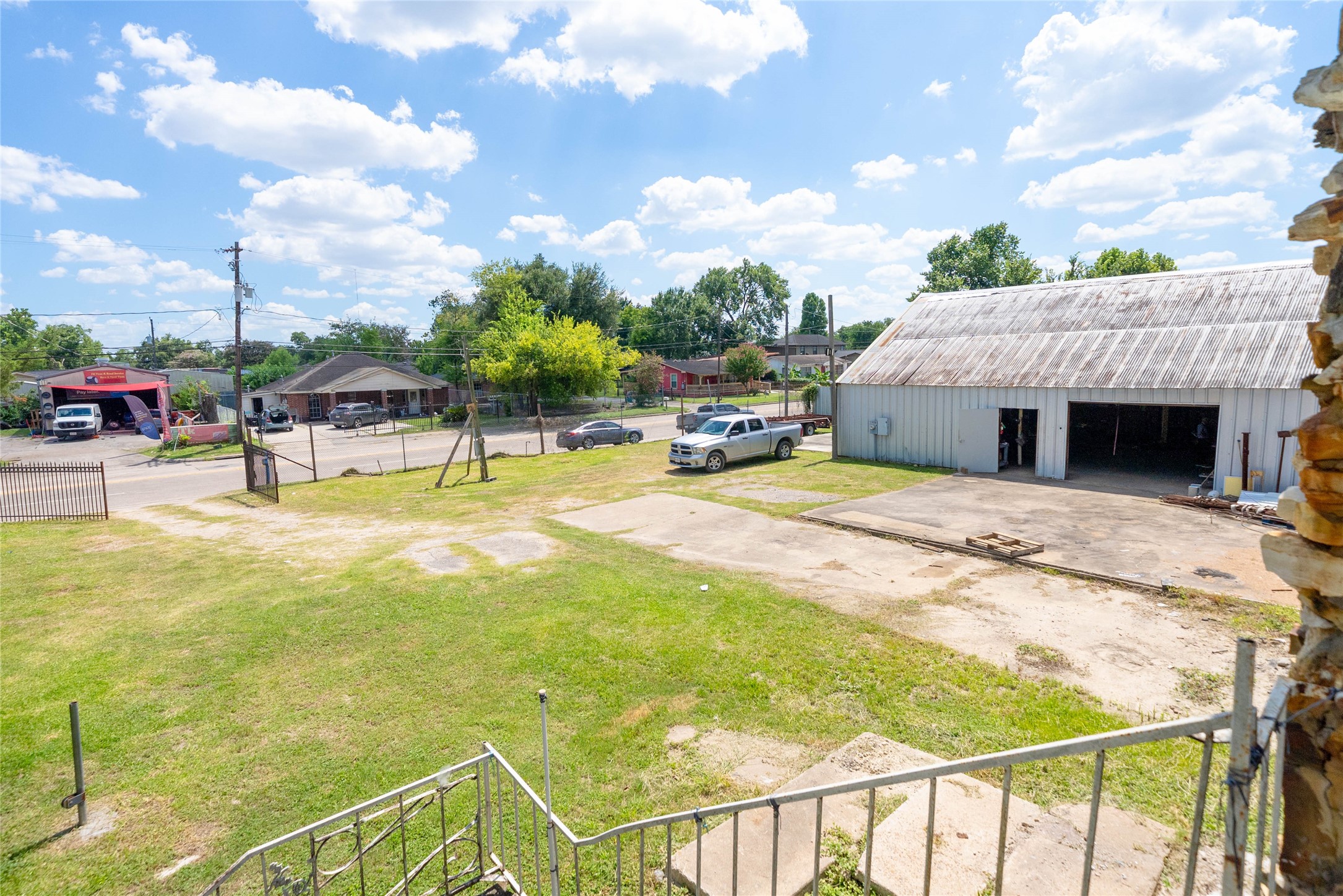 1939 Hopper Road Houston, TX 77093 - Photo 15 of 18 a view of a swimming pool with lawn chairs and iron fence