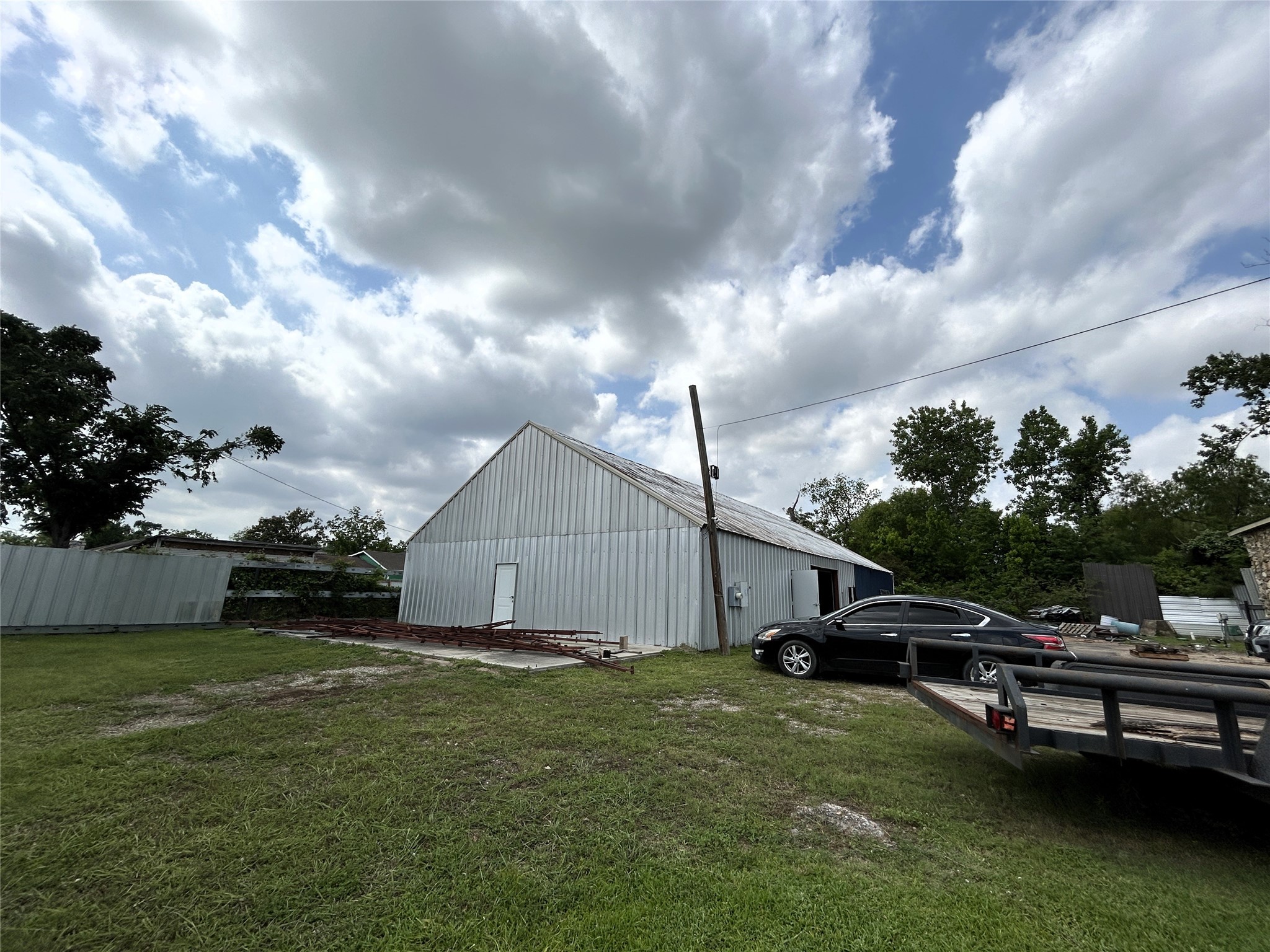 1939 Hopper Road Houston, TX 77093 - Photo 5 of 18 a view of a house with a big yard and a large tree