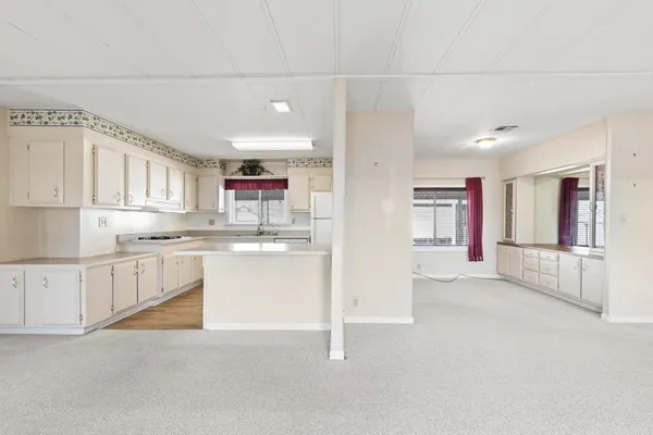 a kitchen with white cabinets and white appliances
