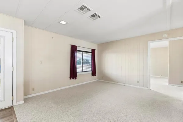 a view of an empty room with a window