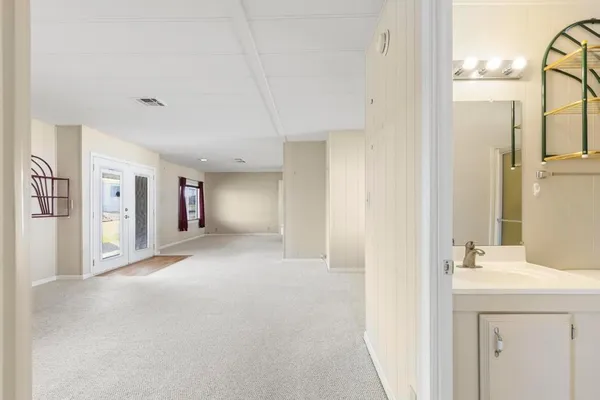 a view of a bathroom with a sink and a mirror