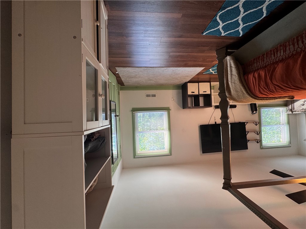 2211 East River Street Anderson, SC 29621 - Photo 29 of 40 This spacious bedroom offers ample natural light through multiple windows and features beautiful hardwood flooring.