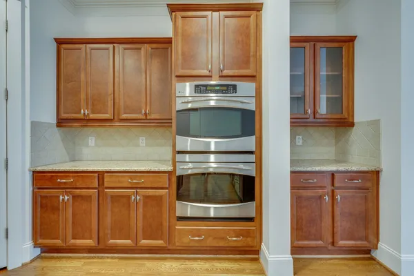 a kitchen with granite countertop a sink and cabinets
