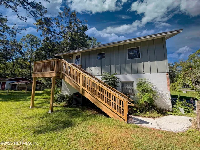 a backyard of a house with wooden floor and fence