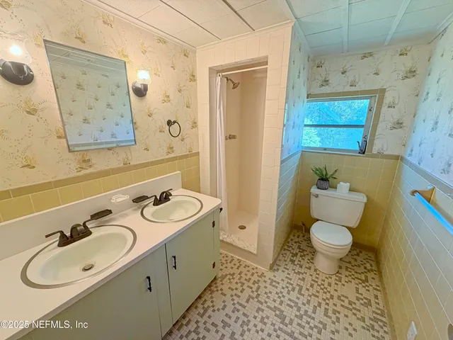 a bathroom with a sink toilet and mirror