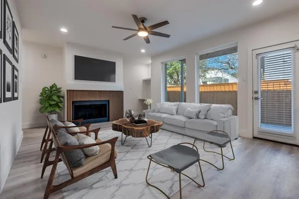 a living room with furniture a fireplace and a flat screen tv