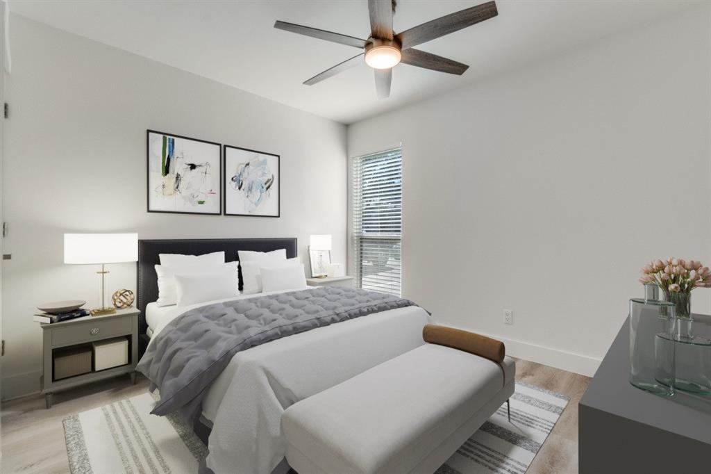 5755 Phoenix Drive, Unit A Dallas, TX 75231 - Photo 14 of 28 a bedroom with a large bed and a chandelier