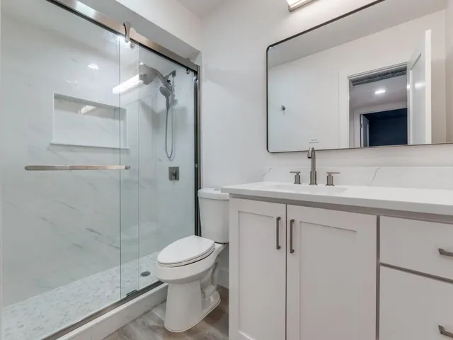 a bathroom with a sink toilet and shower