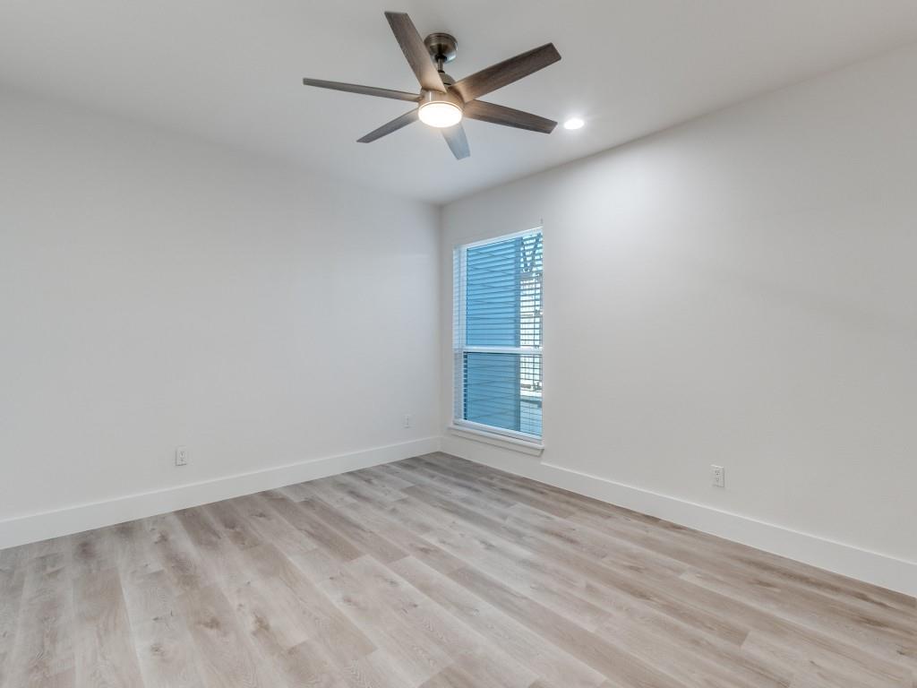 5755 Phoenix Drive, Unit A Dallas, TX 75231 - Photo 17 of 28 wooden floor in an empty room with a window