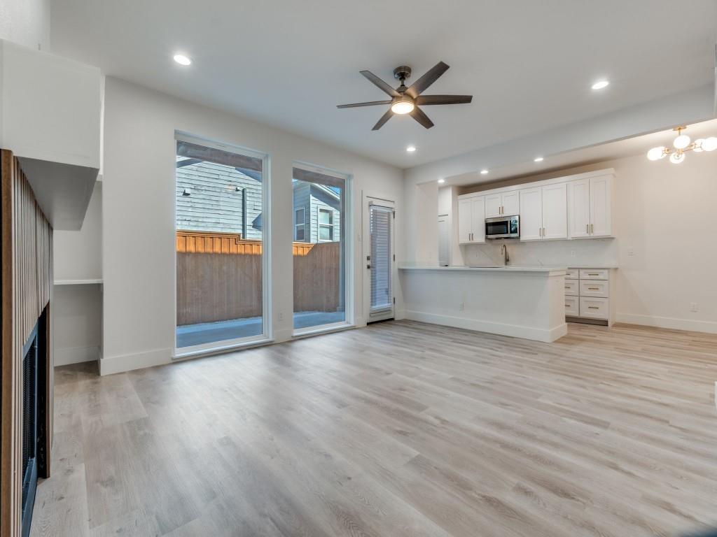 5755 Phoenix Drive, Unit A Dallas, TX 75231 - Photo 6 of 28 a view of a kitchen with a sink dishwasher a refrigerator and wooden floor