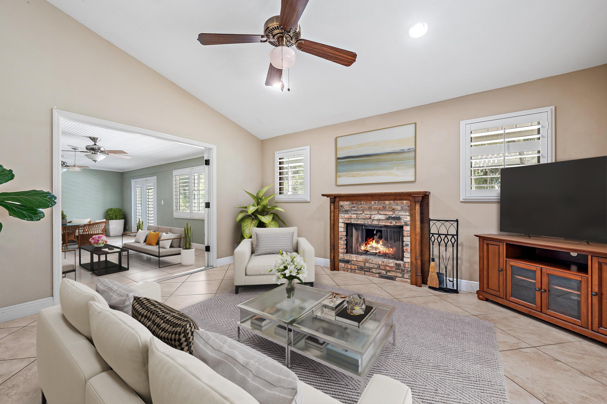 19150 Southeast Jupiter Road Jupiter, FL 33458 - Photo 12 of 43 a living room with furniture a fireplace and a flat screen tv