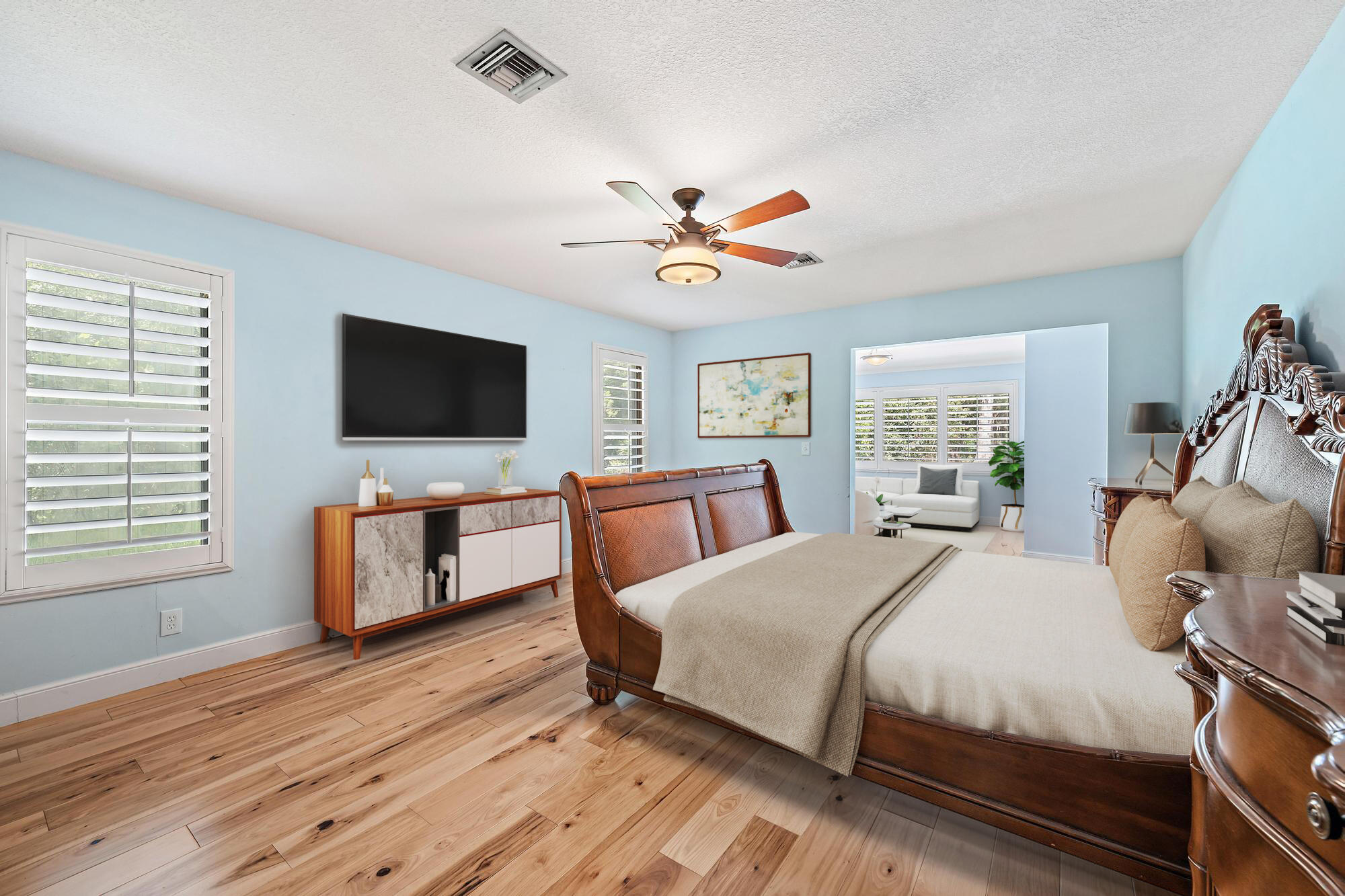 19150 Southeast Jupiter Road Jupiter, FL 33458 - Photo 17 of 43 a bedroom with a bed and a flat screen tv